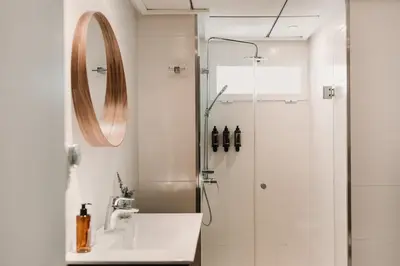 a bathroom with a shower with a sink and a mirror at Parker The Urban Flats in Valencia