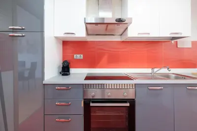 a kitchen with a stove and a sink at Travel Habitat Torres de Serrano in Valencia