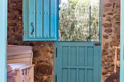 a blue door with a window and a fence at Villa Rotonda in Alquerías del Niño Perdido