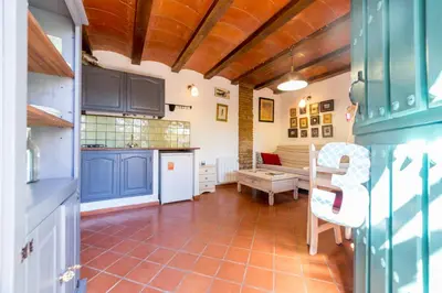 a kitchen with blue cabinets and a table and a couch at Villa Rotonda in Alquerías del Niño Perdido