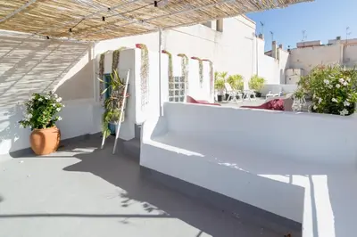 a balcony with white walls and potted plants at La Casa Azul in Alquerías del Niño Perdido