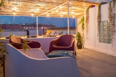 a room with chairs and a view of a building at La Casa Azul in Alquerías del Niño Perdido