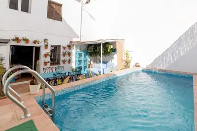 a swimming pool in a villa with a house at La Casa Azul in Alquerías del Niño Perdido