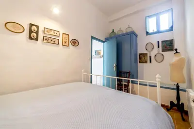 a bedroom with a bed and a blue door at La Casa Azul in Alquerías del Niño Perdido