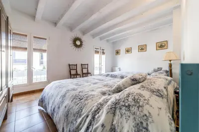 a bedroom with a bed with a blue and white comforter at La Casa Azul in Alquerías del Niño Perdido