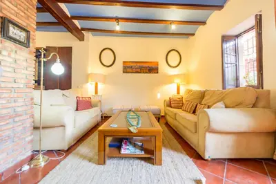 a living room with two couches and a table at Villa Lupita in Alquerías del Niño Perdido