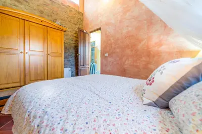 a bedroom with a bed and a wooden cabinet at Villa Lupita in Alquerías del Niño Perdido