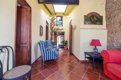 a living room with a red couch and chairs at Villa Lupita in Alquerías del Niño Perdido