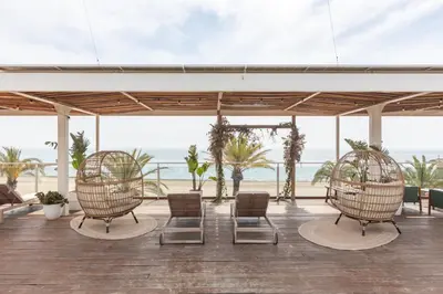 a room with chairs and a view of the beach at Meraki Beach Hotel - Only Adults in Playa Pobla de Farnals