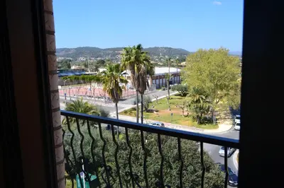 a balcony with a view of a street and palm trees at Gran Hotel Toledo in Onda