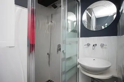 a bathroom with a sink and a glass shower at Apartment Boutique in Valencia