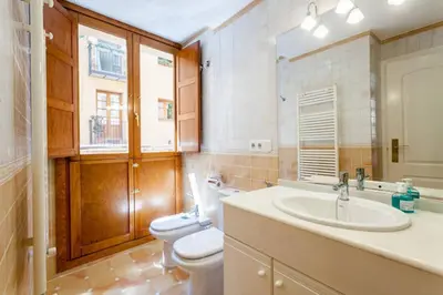 a bathroom with two toilets and a sink at Apartamento Torres in Valencia