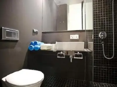 a bathroom with a toilet and a sink and a shower at Apartamentos Hiedra y Tapinería Mercado Central in Valencia