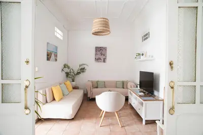 a living room with a couch and a tv at ABCyou Bed&Breakfast in Valencia