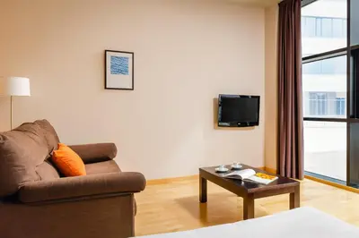 a living room with a couch and a table at Aparthotel Wellness in Paterna