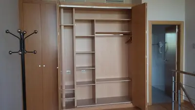 a closet with wooden shelves and a glass door at Aparthotel Wellness in Paterna