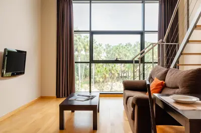 a living room with a couch and a large window at Aparthotel Wellness in Paterna