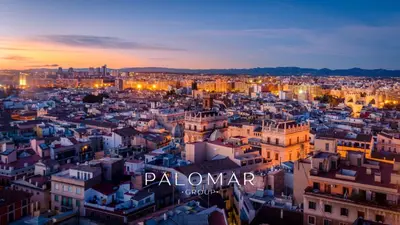 a man walking a dog in front of a building at Edificio Palomar - PalomarGroup in Valencia