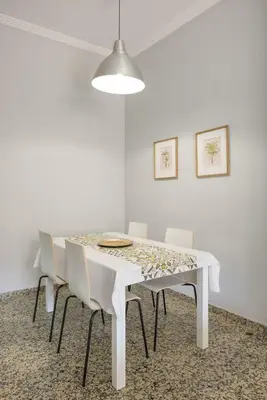 a white dining room with a white table and chairs at Macflats Valencia Puerto in Valencia