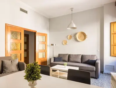 a living room with a couch and a table at Macflats Valencia Puerto in Valencia
