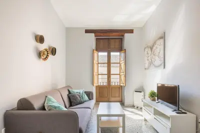a living room with a couch and a tv at Macflats Valencia Puerto in Valencia