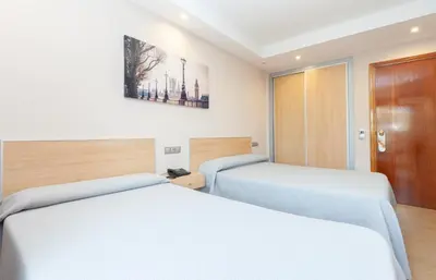 a bedroom with two beds in a room at Hotel Olympia Ronda I in El Puig