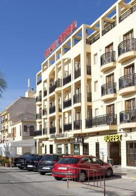 a large white building with cars parked in a parking lot at Hotel Olympia Ronda I in El Puig