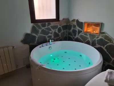 a bath tub in a bathroom with a window at Alojamientos Segóbriga Rural (Artesa) in Segorbe