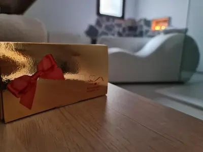 a brown box with a red bow on a table at Alojamientos Segóbriga Rural (Artesa) in Segorbe