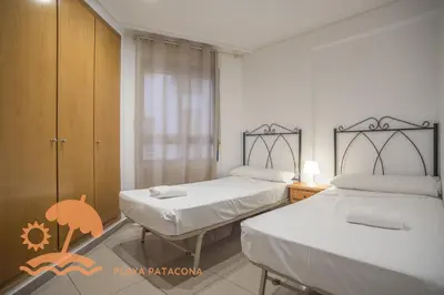a bedroom with two beds and a window at Patacona Relax & Resort Apartments in Valencia