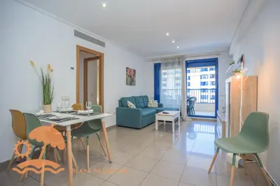a living room with a table and chairs and a couch at Patacona Relax & Resort Apartments in Valencia