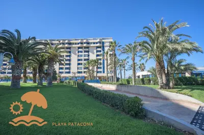 a resort with palm trees and a building at Patacona Relax & Resort Apartments in Valencia