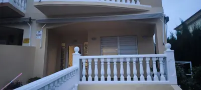 a white railing on a house with a porch at Adosado Calle Mar Cantabrico in Puebla de Vallbona