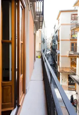 an empty street in a city with buildings at Total Valencia Cathedral in Valencia