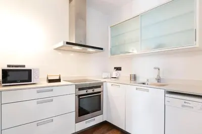 a kitchen with white cabinets and a microwave at Total Valencia Cathedral in Valencia