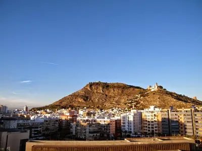 a view of a city with a mountain in the background at Apartamentos Milenio in Cullera