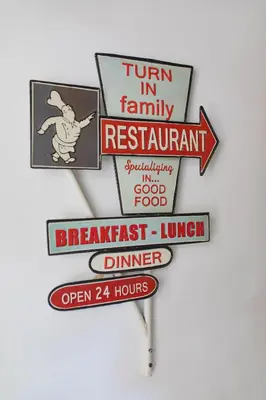 a group of signs hanging on a wall at Hostal Virginia in Favareta