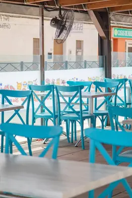a group of blue tables and chairs on a patio at Hostal Virginia in Favareta