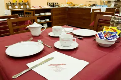 a table with plates and cups on a red table cloth at Torrijos in Cheste
