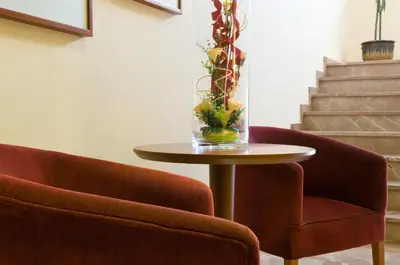 two chairs and a table with a vase on it at Torrijos in Cheste