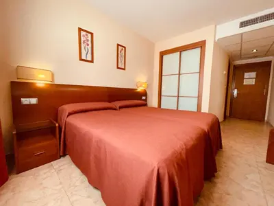 a bedroom with a large bed with a red blanket at Torrijos in Cheste
