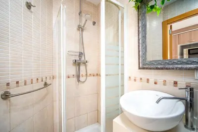 a bathroom with a sink and a shower at Ático de Lujo Plaza Ayuntamiento in Valencia