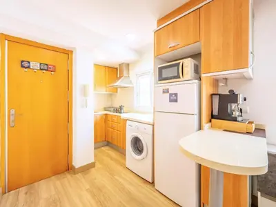 a kitchen with a white refrigerator and a washing machine at Ático de Lujo Plaza Ayuntamiento in Valencia