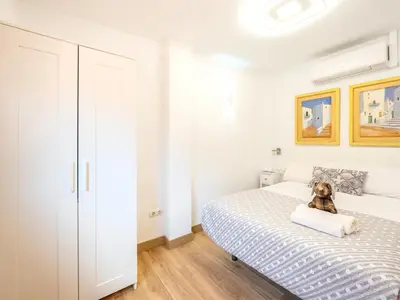 a bedroom with a bed with a teddy bear sitting on it at Ático de Lujo Plaza Ayuntamiento in Valencia