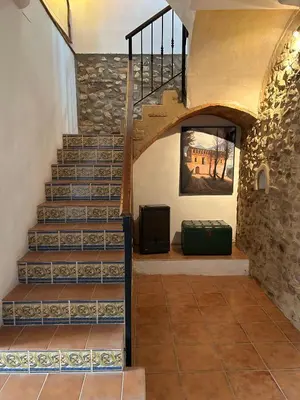 a staircase in a house with a stone wall at Apartamentos turísticos 