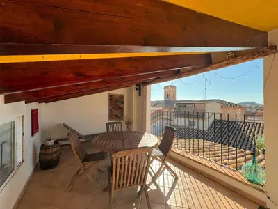 a patio with a table and chairs on a balcony at Apartamentos turísticos 
