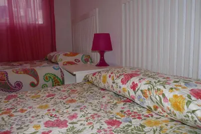 a bedroom with two beds and a lamp on a table at Apartment Savoy in Valencia