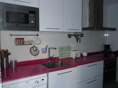 a kitchen with a sink and a microwave at Apartment Savoy in Valencia