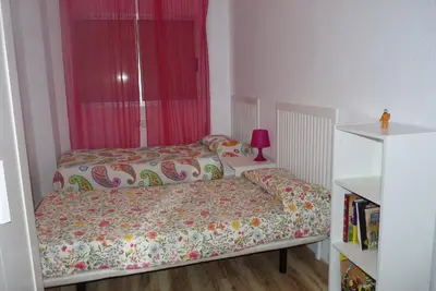 a small bedroom with two beds and a window at Apartment Savoy in Valencia