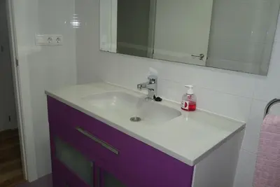 a bathroom with a sink and a mirror at Apartment Savoy in Valencia